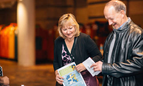 woman and man reading a map at an event