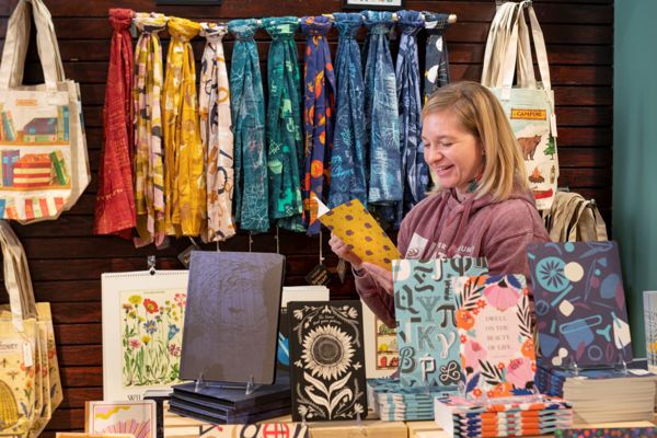 Guest Looking At A Notebook In The Shop on Expandable Content Card