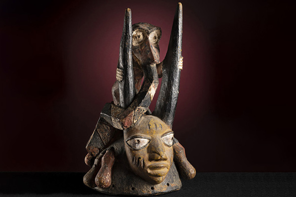 African mask with small animal on top