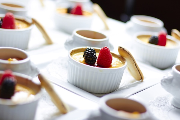 Desserts in white bowls in a row 