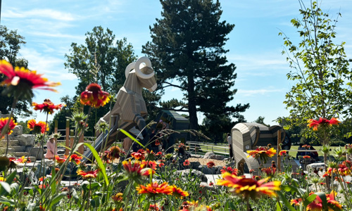 Flowers blooming in foreground; Ram structure in background