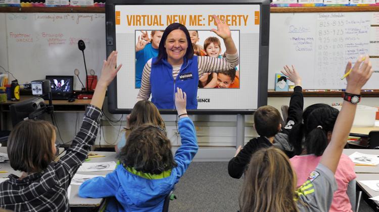 Students raise their hands and engage during a virtual class.