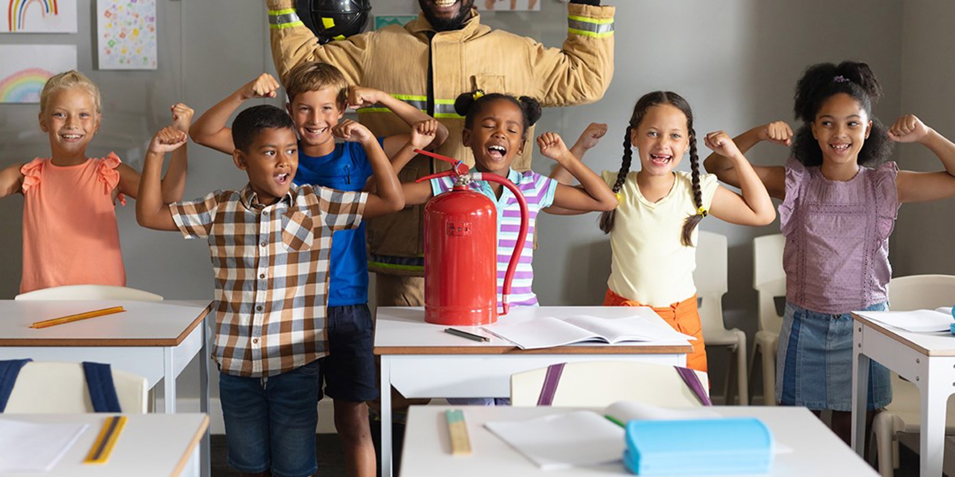 A group of students flexing their biceps and smiling